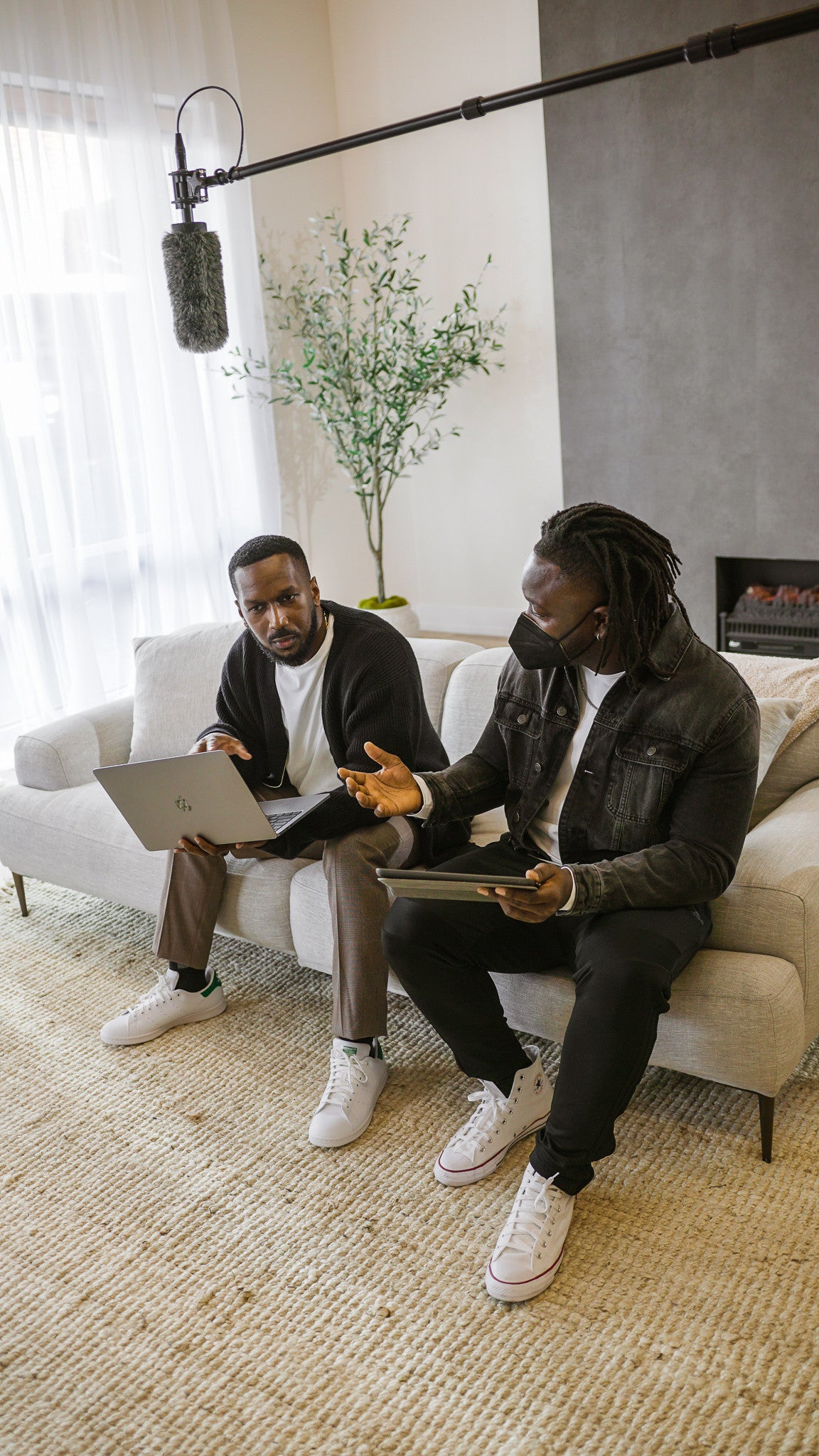Two Black colleagues collaborating around a laptop
