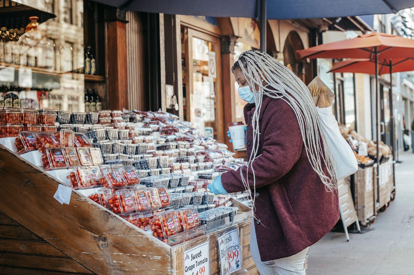 Black woman shopping at a vibrant outdoor market