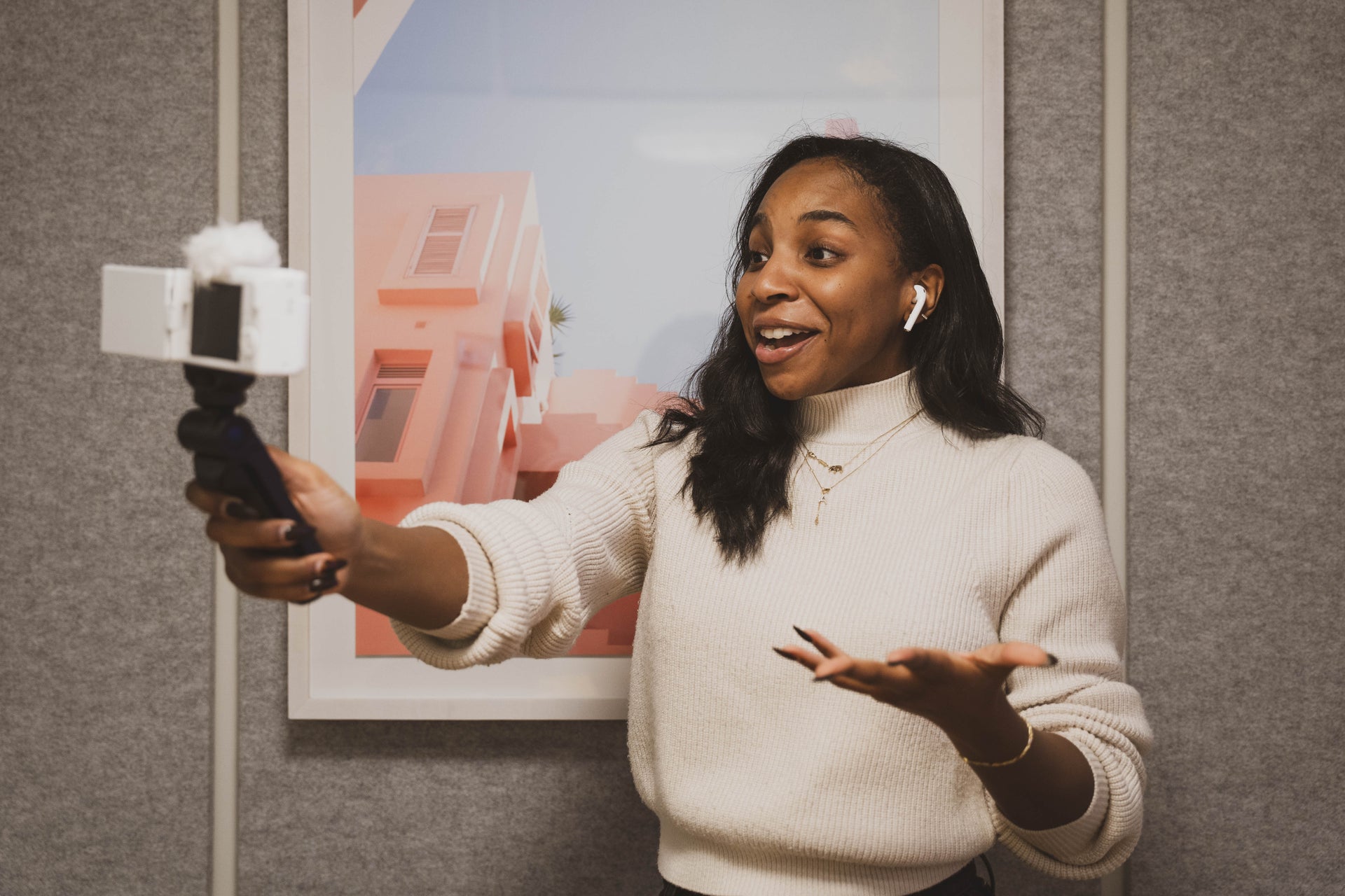 Black creator recording video content with her phone